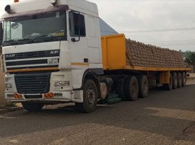Flatbed trailer loaded with bagged cargo