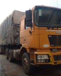 Truck hauling tarpaulin-covered cargo